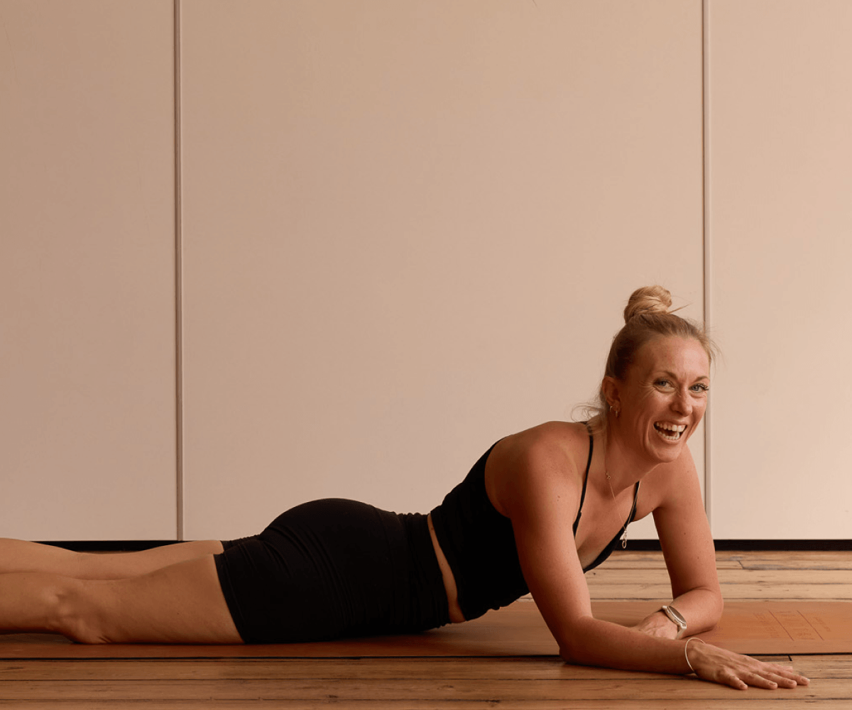 Louise brown smiling and laughing while teaching her Peckham Somatic Yin Yoga class