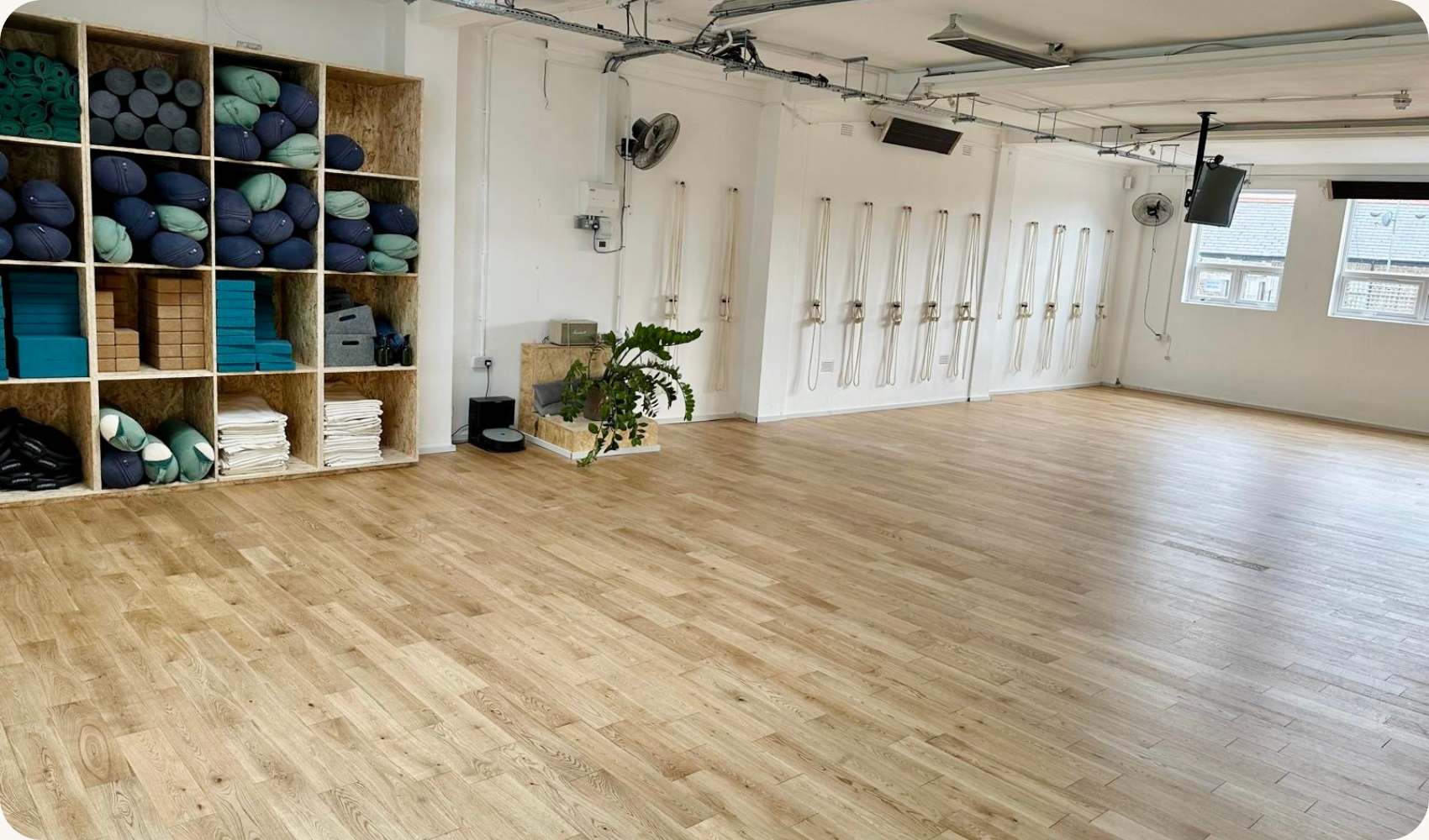 The bright, fully equipped interior of the Yogarise Queen's Park yoga studio in North West London.