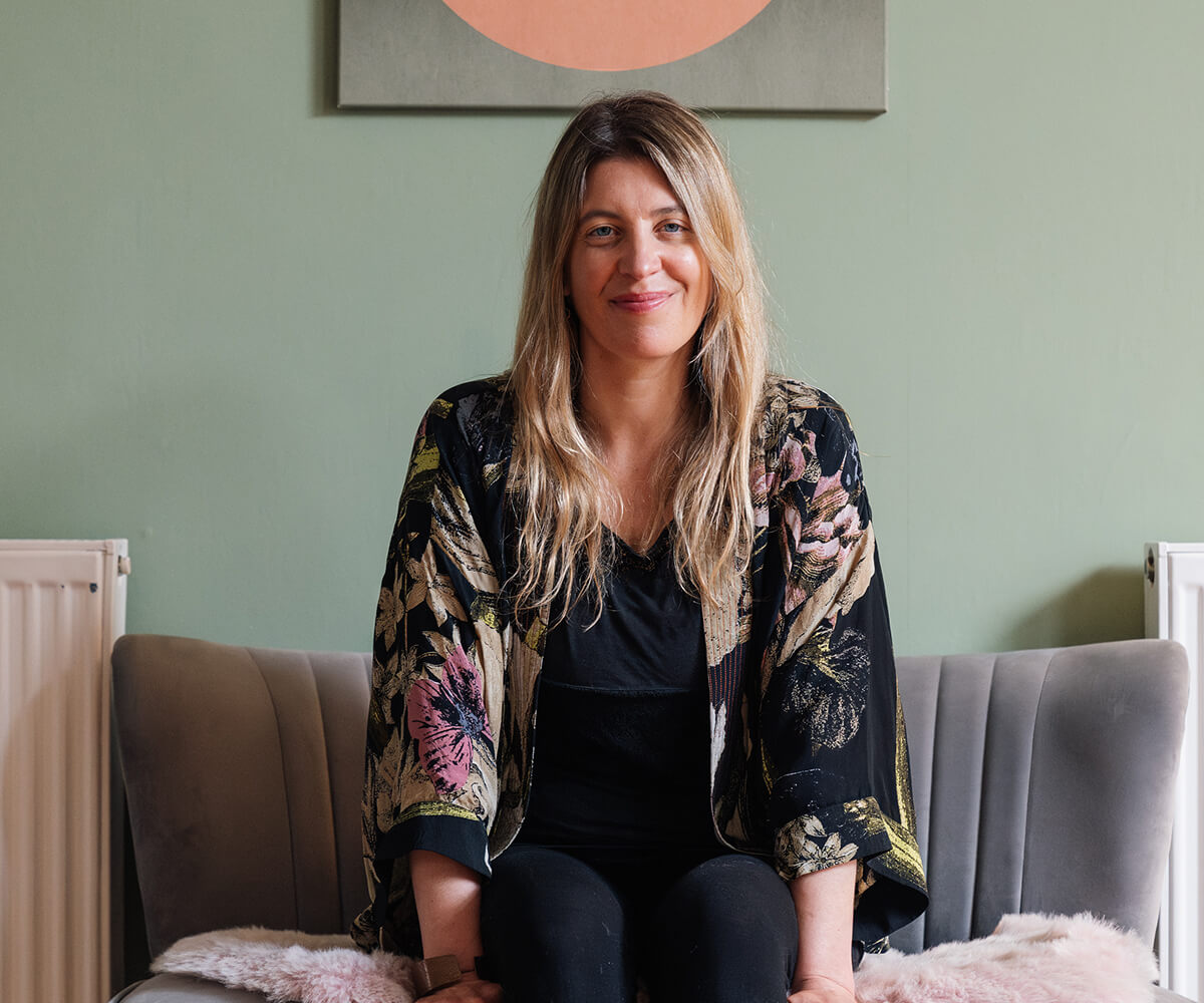 Louise brown smiling and laughing while teaching her Peckham Somatic Yin Yoga class